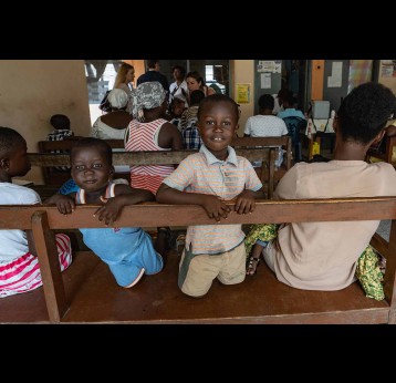 Boy in immunisation waiting room, Ghana Gavi/2019/Tony Noel