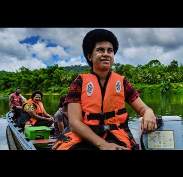 Health workers deliver life-saving vaccines by boat Credit: WHO