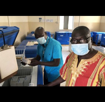 @ UNICEFSouthSudan/Willemot Evans Ariko Shawish (right) Manager, Expanded Programme for Immunization, Ministry of Health, Western Equatoria State and Daniel Drinchi, Health Officer, UNICEF Yambio field office, inspecting the central cold chain storage in the state capital Yambio. The cold chain is now used for measles and polio vaccines among others and will soon also be used for COVID-19 vaccines.