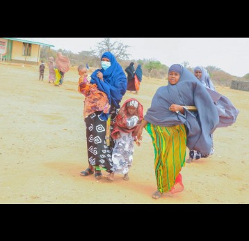 Halima Adan, left, leaving a COVID-19 vaccine strategy meeting in Liboi, Kenya