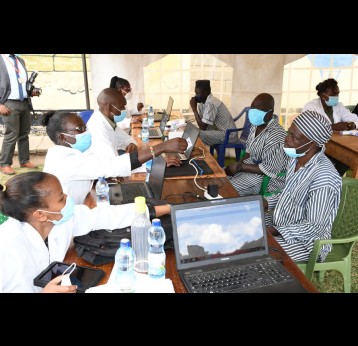 Health workers prepare for a vaccination session at Kamiti Maximum Security Prison