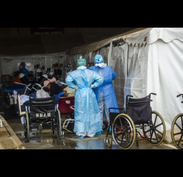 Health care workers and patients in the temporary outside area Steve Biko Academic Hospital created to screen and treat suspected Covid-19 cases in Pretoria. Alet Pretorius/Gallo Images via Getty Images