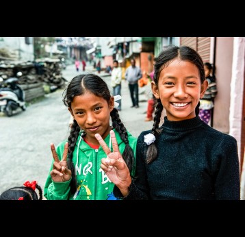 Young girls flash the victory sign as part of a campaign that stands for Victory over Diseases. Gavi/Nepal/Oscar Seykens
