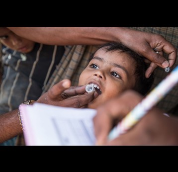 A young boy receives the oral cholera vaccine during a door-to-door vaccination session. Credit: Gavi/Isaac Griberg