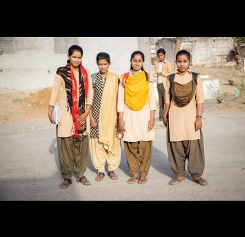 Four girls in traditional School uniform in the morning sun on their way to School, in a Village in Rajasthan, India. Gavi/2021/Benedikt v.Loebell