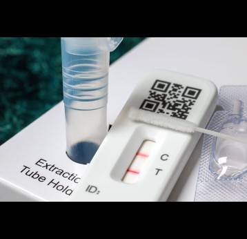 Close-up of rapid COVID-19 home lateral flow antigen test with positive result