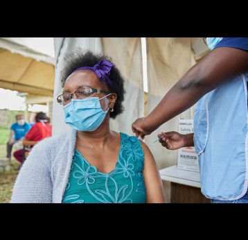 Woman receiving COVID-19 vaccine. Photo credit: UNICEF