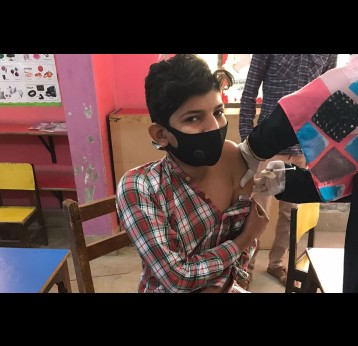 A student gets his second COVID-19 vaccination shot at Herald Citi School, Karachi. Photo: Saadeqa Khan