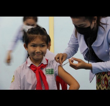 A girl receives her first dose of HPV vaccine in Laos