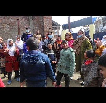 Members of the disability organisation, who also serve as the teachers, seen playing with students on Saturday, as schools opened in Kashmir after a long break due to COVID-19. Photo Credits: Kaleem Geelani