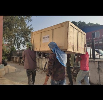 UNICEF Nepal/2021 – Workers carrying parts and accessories for the installation of the COVAX-supported walk-in cooler at the Provincial Health Logistics Management Centre in Dhangadhi, Sudurpaschim Province.