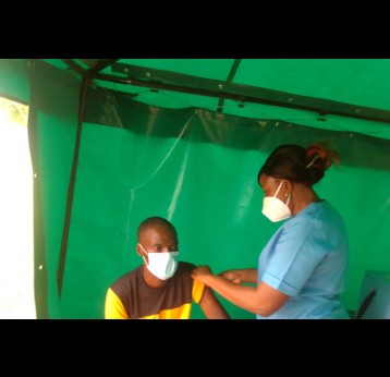Nurse Chipo Chapfika vaccinates a patient in Chitungwiza