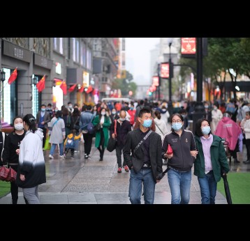 people in face mask to prevent coronavirus, walking on Jianghan Road. Jianghan Road is a famous commercial street in Wuhan