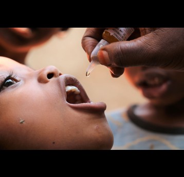 A child receiving polio drops. Credit: Moses Havyarimana