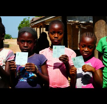 Three girls holding their HPV vaccination cards during a vaccination session in Liberia. Credit: Gavi/2016/Duncan Graham-Rowe