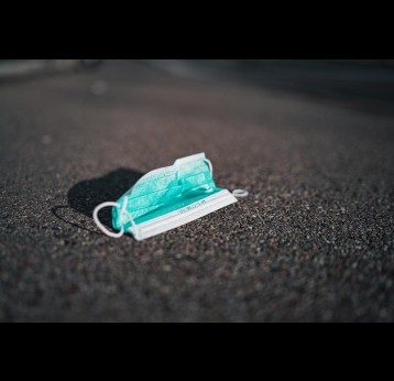A medical face mask on the ground. Credit: Claudio Schwarz on Unsplash