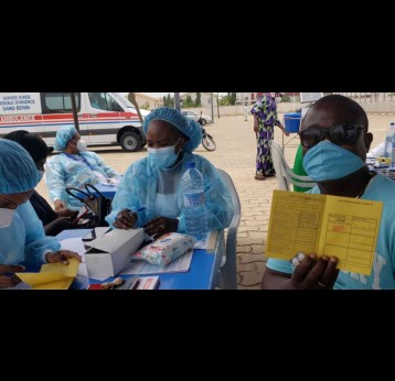 Un citoyen vacciné contre la COVID-19 montre sa carte de vaccination. Crédit : Ministère de la Santé du Bénin