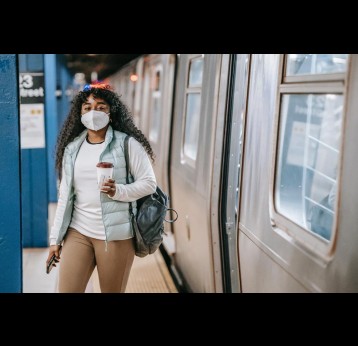 Woman wearing a mask at a train station. Credit: Uriel Mont on Pexels