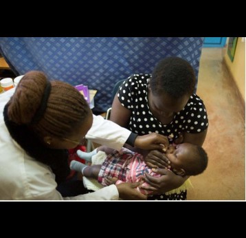 A volunteer clinician gives an infant a dose of the vaccine in Kaptembwa. Credit: Julie Mwabe, CDC Kenya