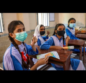 Adolescent girls proudly show the ink mark on the tip of their finger: proof that they have been vaccinated against measles and rubella during a nationwide campaign in Karachi, Sindh province, Pakistan. Credit: Gavi/2021/Asad Zaidi