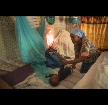 Mercy Shem, a mother of four living in the bushy village of Mukende now has an easy time with her youngest son, Amory Shem,because he has received the first dose of malaria vaccine. Kenya, 2023. Credit: Gavi/2023/Kelvin Juma