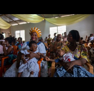 Mothers and children at a vaccination spot in Buduburam in the Gomoa East District of Ghana. Credit: The Global Fund/Nana Kofi Acquah