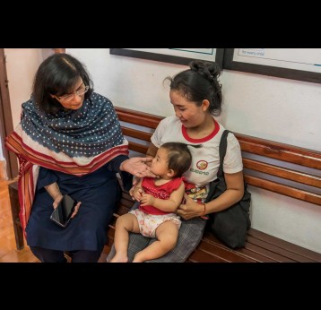 Gavi CEO Dr Sania Nishtar sits with a mother and child during a recent vaccination session in Lao PDR. Credit: Gavi/2024/Running Reel