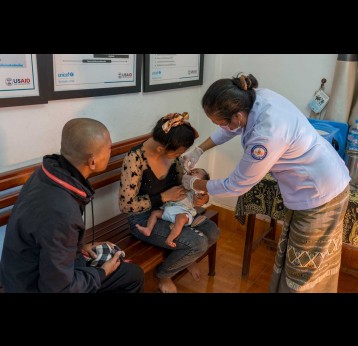 A healthcare worker administers an oral vaccine to a child at a health centre in Lao PDR. Credit: Gavi/2024/Running Reel
