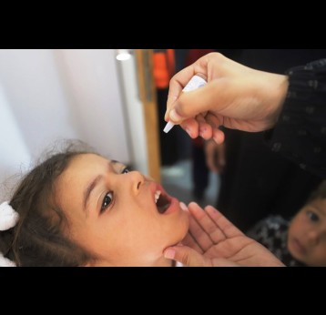 A girl receives drops of an orally administered vaccine. Credit: IFRC/2024