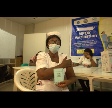 "A health worker receiving an mpox vaccination with a card at the 34 Military Hospital in Freetown. Credit: Saidu Bah
