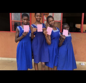 Edaiken Primary School students showing their vaccination cards. Credit: JSI