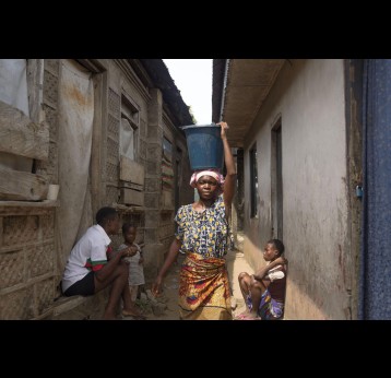 Permanent, 23, fetches water from the river behind her house in the Onuegbu community in Bayelsa State, where she sells grilled fish. Ogbia, Nigeria. December 17, 2024. Credit:  Jérôme Sessini/ Magnum Photos