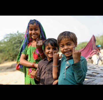 Young boys and girls proudly show the ink mark on the tip of their finger, showing they have been vaccinated against measles and rubella during the nationwide campaign in Sindh province, Pakistan. Credit: Gavi/2021/Asad Zaidi