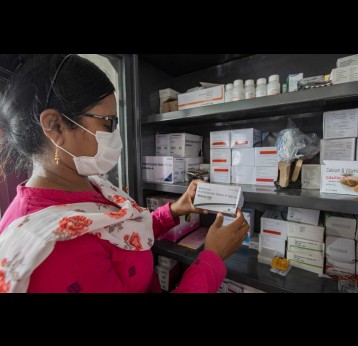 A Nurse examines medicine on bord a hospital boat, Sunderbarns, India. Credit: Gavi/2022/Benedikt v.Loebell