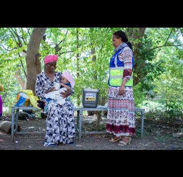 A mother awaits for her child to receive the measles vaccine from a health worker during a routine vaccination session in Ethiopia. Credit: Gavi/2024/Mulugeta Ayene