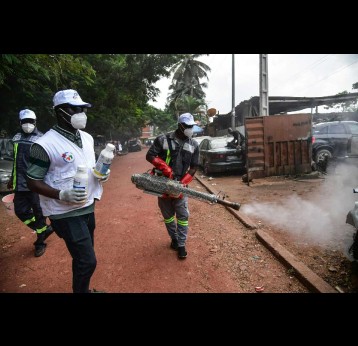 Public health officials spray the streets in Abidjan, Côte d'Ivoire, in 2023 to eliminate mosquitoes that cause dengue fever. Sia Kambou/AFP/Getty Images