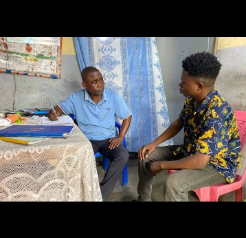 Head nurse Adelon Kweyinatabia speaks with a patient during a consultation at the Kinkenda Community Health Centre, in the Mbinza Météo health zone, Ngaliema municipality, Kinshasa. Credit: Yanne Mbiyavanga