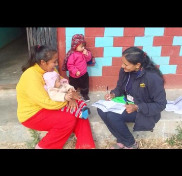 Health workers going door to door to check if children have received their vaccinations. Credit: Radha Poudel