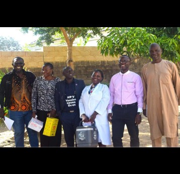 JSI and partner staff with health workers, including a nurse (second and fourth from left), after administering HPV vaccinations to students. Credit: Richard Adupong, JSI