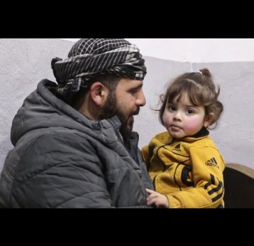 Lana sits safely in her father’s arms after recovering from meningitis in Aleppo. Credit: WHO