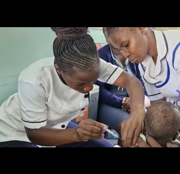 A medical provider administers malaria vaccine to a seven month old baby at the Jaramogi Oginga Odinga Teaching and Referral Hospital, a regional health facility in Western Kenya. Credit: Angeline Anyango. 