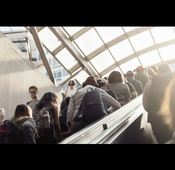 Morning commuters riding an escalator. Credit: Connor Gan