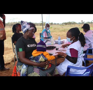 A mother awaits as her child receives treatment at Inkosuk village in Kajiado County during Entepesi Kenya's medical camp. Credit: Susan Methamo