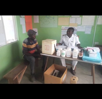 Primary care nurse Richard Vherukayi at Nyamatsito health centre attending to a patient. Credit: Enos Denhere