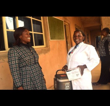 School principal Afodia Yusuf (left) in discussion with a nurse (right) before commencing HPV vaccination  for students. Credit: Richard Adupong, JSI