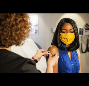 Health worker places a plaster on a patient’s arm after vaccination. Credit: CDC via Unsplash
