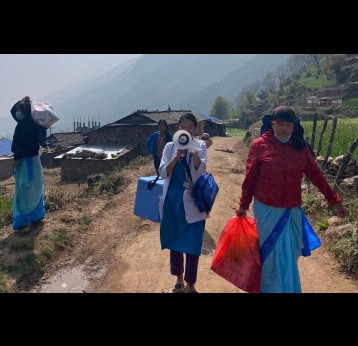 A health worker announces a vaccination session. Credit: Nepal National Immunization Program