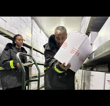 Managers at EPSS in Addis Ababa move vaccine stocks inside a central cold room. Credit: Moses Havyarimana