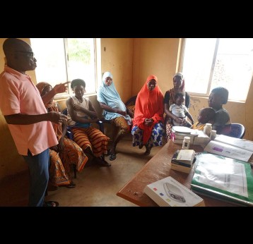James Tanko sensitising mothers before vaccination. Credit: Afeez Bolaji