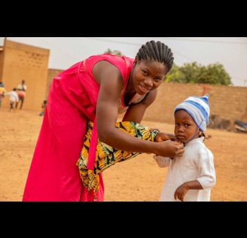 A mother and her child in Burkina Faso during a malaria vaccination session. Credit: Gavi/2024/Arnauld Yalgwueogo